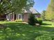 Charming brick house with lush lawn, a well-maintained landscape and a welcoming front entrance at 6010 Fawnwood Dr, Greenwood, IN 46143