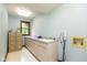 Spacious laundry room with ample counter space, storage cabinets, and utility sink at 6010 Fawnwood Dr, Greenwood, IN 46143