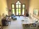 Bright living room with a large arched window, piano, and comfortable seating arrangement at 6010 Fawnwood Dr, Greenwood, IN 46143