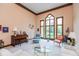 Bright living room with high ceilings, large windows, and comfortable seating arrangements at 6010 Fawnwood Dr, Greenwood, IN 46143