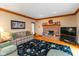 Cozy living room with brick fireplace, comfortable seating, and beautiful accents at 6010 Fawnwood Dr, Greenwood, IN 46143