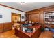 Spacious home office featuring rich wood accents and abundant storage with view to bedroom at 6010 Fawnwood Dr, Greenwood, IN 46143