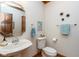 Charming powder room with pedestal sink, decorative mirror and wall art at 6010 Fawnwood Dr, Greenwood, IN 46143