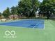 A community tennis court is surrounded by trees and has lighting for evening play at 6010 Fawnwood Dr, Greenwood, IN 46143