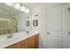 Elegant bathroom with double sinks, a large mirror, modern lighting, and decor at 6615 School Branch Dr, Brownsburg, IN 46112