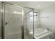 Bright bathroom featuring a shower, a large soaking tub, and a window at 6615 School Branch Dr, Brownsburg, IN 46112