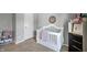Well-organized Bedroom featuring a white crib, toy storage, and soft, neutral tones at 6615 School Branch Dr, Brownsburg, IN 46112