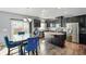 Kitchen with stainless steel appliances, dark wood cabinets, granite countertops and sliding glass doors at 6615 School Branch Dr, Brownsburg, IN 46112