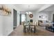 Bright dining room featuring neutral color furniture and view into the open floor plan of the living spaces at 6615 School Branch Dr, Brownsburg, IN 46112