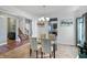 The dining room with a modern chandelier, neutral colors and a view of stairs to the second floor at 6615 School Branch Dr, Brownsburg, IN 46112