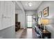 Welcoming foyer boasts wood floors, console table and decor, and lots of natural light at 6615 School Branch Dr, Brownsburg, IN 46112