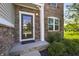 Inviting front entrance features stone accents, a decorative storm door and well-maintained landscaping at 6615 School Branch Dr, Brownsburg, IN 46112