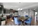 Eat-in kitchen with stainless steel appliances, dark wood cabinets, island and blue upholstered chairs at 6615 School Branch Dr, Brownsburg, IN 46112