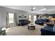 Open concept living room and kitchen area with neutral walls and dark blue upholstered seating at 6615 School Branch Dr, Brownsburg, IN 46112