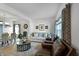 Open-concept living room featuring neutral decor, hardwood floors, and views into the dining area at 6615 School Branch Dr, Brownsburg, IN 46112