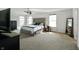 Spacious main bedroom featuring a large bed with a tufted headboard, and a ceiling fan at 6615 School Branch Dr, Brownsburg, IN 46112