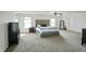 Large main bedroom with a tufted headboard bed, carpet flooring, and bright, natural light at 6615 School Branch Dr, Brownsburg, IN 46112