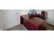 Well-lit home office with a large desk, a comfortable chair, and a carpeted floor at 6615 School Branch Dr, Brownsburg, IN 46112