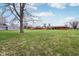 Expansive backyard featuring a large lawn and mature trees at 6905 E Hanna Ave, Indianapolis, IN 46203