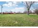 Vast backyard showing the home's exterior and a large grassy area at 6905 E Hanna Ave, Indianapolis, IN 46203
