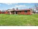 View of the brick home with a well-manicured lawn at 6905 E Hanna Ave, Indianapolis, IN 46203