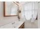 Cozy bathroom featuring patterned wallpaper and a decorative mirror and window at 6905 E Hanna Ave, Indianapolis, IN 46203