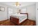 Bedroom with ceiling fan, windows, and a decorative bed at 6905 E Hanna Ave, Indianapolis, IN 46203