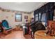 Cluttered bedroom with a rocking chair, window, and a desk at 6905 E Hanna Ave, Indianapolis, IN 46203