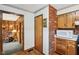 Hallway featuring classic brick accents, functional cabinetry, and seamless transitions to living spaces at 6905 E Hanna Ave, Indianapolis, IN 46203
