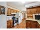 Bright kitchen equipped with modern appliances, wood cabinets, and a seamless flow to adjacent spaces at 6905 E Hanna Ave, Indianapolis, IN 46203