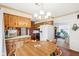 Cozy kitchen featuring warm wood cabinetry, brick accents, and adjacent dining area with natural light at 6905 E Hanna Ave, Indianapolis, IN 46203