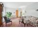 Cozy living room featuring floral sofas, a stylish coffee table, and ample seating for gatherings at 6905 E Hanna Ave, Indianapolis, IN 46203