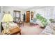 Bright living room showcasing comfortable seating, an elegant display cabinet, and a warm, welcoming ambiance at 6905 E Hanna Ave, Indianapolis, IN 46203