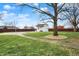 Backyard with a pool house, a pool cover, and a walkway that leads to the side of the house at 6958 W Brier Creek Dr, New Palestine, IN 46163