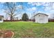 A well-maintained lawn featuring a pool house, a tree, and a dark brown wooden fence at 6958 W Brier Creek Dr, New Palestine, IN 46163