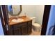 Cozy bathroom featuring vanity with sink, mirror, and toilet, offering functionality and style at 6958 W Brier Creek Dr, New Palestine, IN 46163