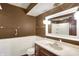 A cozy bathroom featuring an integrated sink and vanity with a decorative mirror at 6958 W Brier Creek Dr, New Palestine, IN 46163