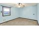 Bedroom featuring neutral carpet, light blue walls, and a window letting in natural light at 6958 W Brier Creek Dr, New Palestine, IN 46163