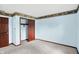 A blue bedroom with wood trim, an accent border, and a closet with sliding doors at 6958 W Brier Creek Dr, New Palestine, IN 46163