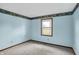 A light blue bedroom showcasing a window allowing for great natural light at 6958 W Brier Creek Dr, New Palestine, IN 46163