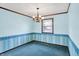 Cozy dining room featuring a large window, chandelier, and comfortable carpet at 6958 W Brier Creek Dr, New Palestine, IN 46163