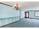 Cozy dining room featuring a large window, chandelier, and comfortable carpet at 6958 W Brier Creek Dr, New Palestine, IN 46163