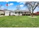 Charming single-story home featuring a well-manicured lawn and an inviting front porch with white railings at 6958 W Brier Creek Dr, New Palestine, IN 46163