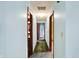 Hallway with light blue walls, doors leading to rooms, and carpeted floor at 6958 W Brier Creek Dr, New Palestine, IN 46163