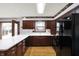 Well-appointed kitchen featuring dark wood cabinets, modern appliances, and a bright window over the sink at 6958 W Brier Creek Dr, New Palestine, IN 46163