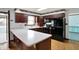 Spacious kitchen featuring dark wood cabinets, modern appliances, and light countertops at 6958 W Brier Creek Dr, New Palestine, IN 46163