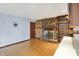 Living room featuring a brick fireplace, wood paneled wall, built-in shelving at 6958 W Brier Creek Dr, New Palestine, IN 46163