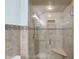 Walk-in shower featuring beautiful tile, a glass door, and a shower head with mounted controls at 6958 W Brier Creek Dr, New Palestine, IN 46163