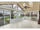 Enclosed sun room features skylights, view of the backyard, and light tile flooring at 6958 W Brier Creek Dr, New Palestine, IN 46163