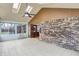 Enclosed sun room featuring a brick wall, skylights and light tile flooring at 6958 W Brier Creek Dr, New Palestine, IN 46163